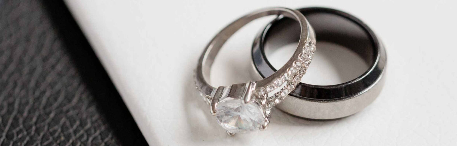 Two rings on a white surface with a textured gray background