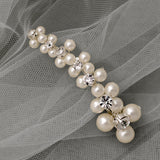 Pearl hair clip with crystals on a gray fabric background