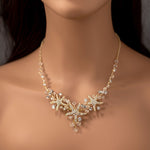 Three crystal covered starfish are surrounded by crystal stones and beads for a sparkly look. Matching bracelet here.