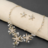Three crystal covered starfish are surrounded by crystal stones and beads for a sparkly look. Matching bracelet here.