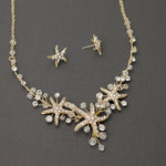 Three crystal covered starfish are surrounded by crystal stones and beads for a sparkly look. Matching bracelet here.
