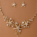 Three crystal covered starfish are surrounded by crystal stones and beads for a sparkly look. Matching bracelet here.