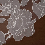 Royal Wedding Veil with Organza Flowers Cassandra Lynne A close-up of sheer floral lace fabric with white embroidered outlines over a dark brown background.