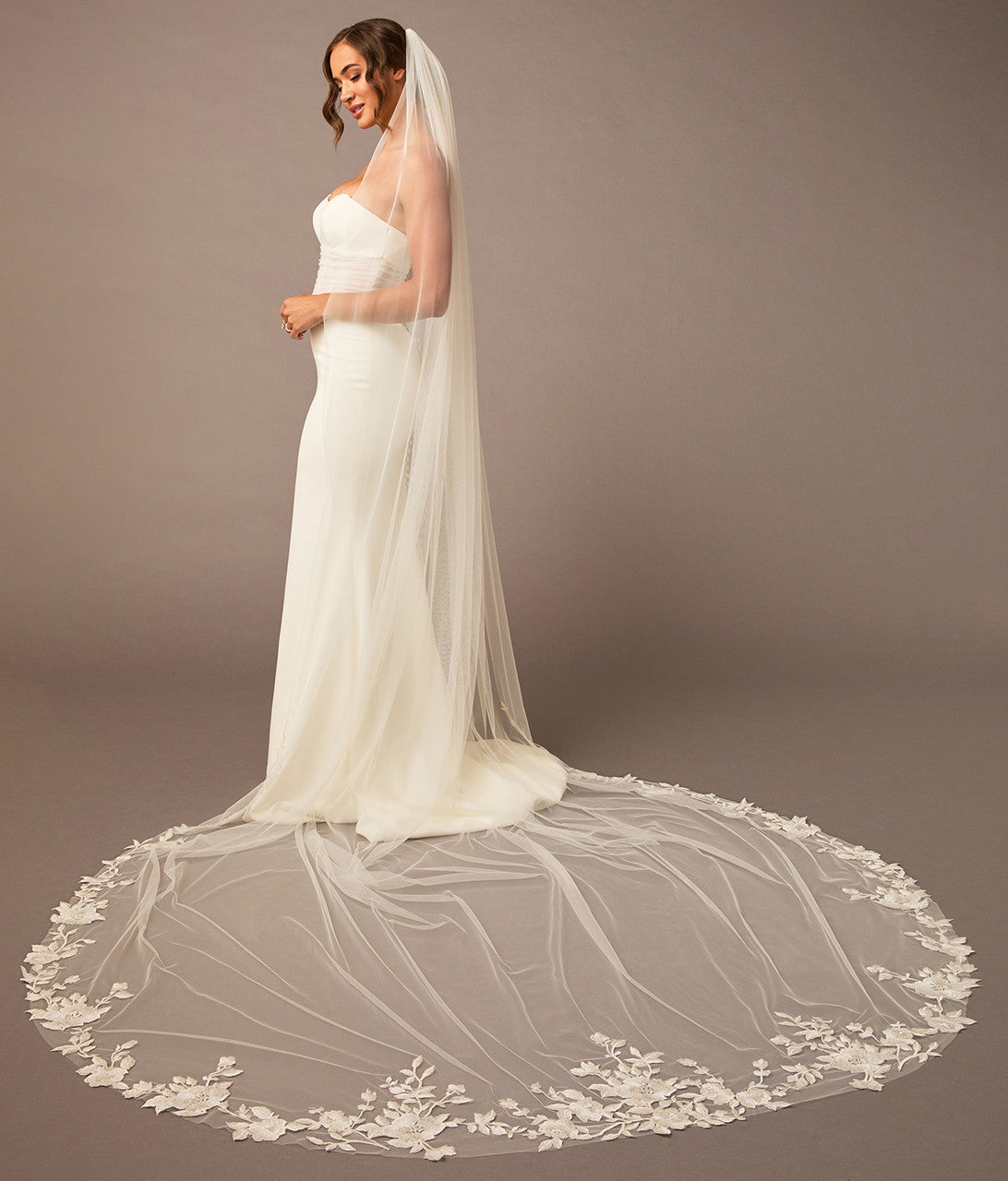Cathedral Luxe Tulle Lace Wedding Veil Bridal gown with a long, elegant veil on a plain background