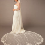 Cathedral Luxe Tulle Lace Wedding Veil Bridal gown with a long, elegant veil on a plain background