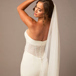 Cathedral Luxe Tulle Lace Wedding Veil Woman wearing a wedding dress with a long veil against a plain background
