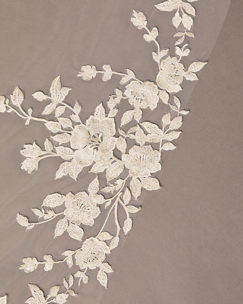 Cathedral Luxe Tulle Lace Wedding Veil Floral lace trim on a beige fabric background