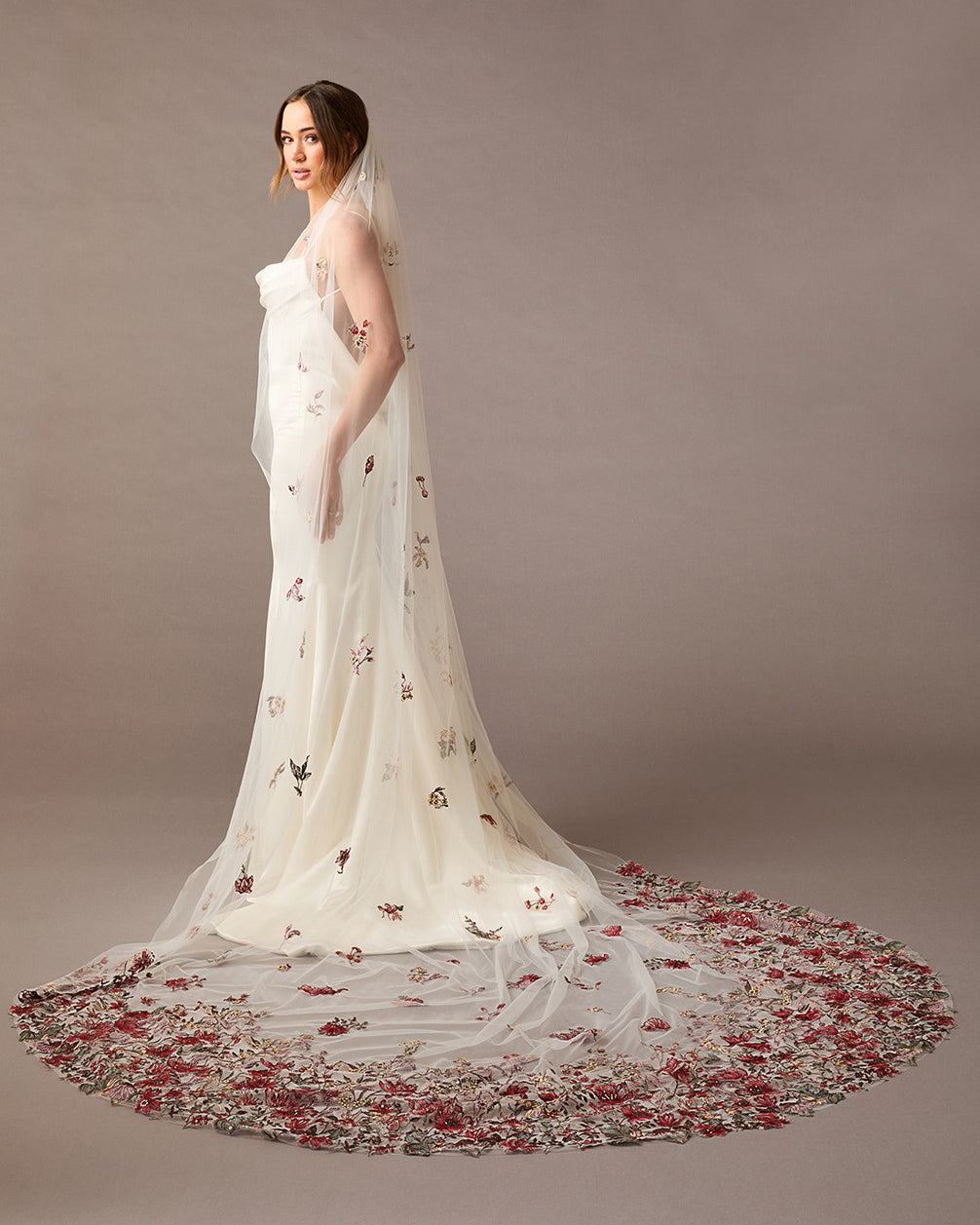 Cathedral Wedding Veil with Burgundy and GReen Flower Lace Woman wearing a  wedding dress with floral details on a brown background