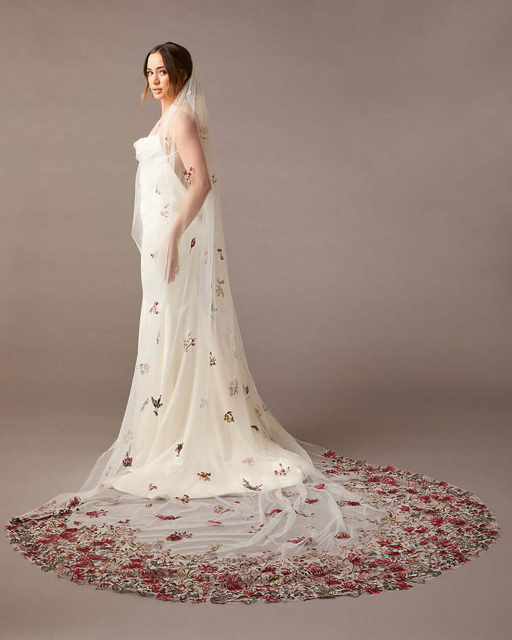 Cathedral Wedding Veil with Burgundy and GReen Flower Lace Woman wearing a  wedding dress with floral details on a brown background
