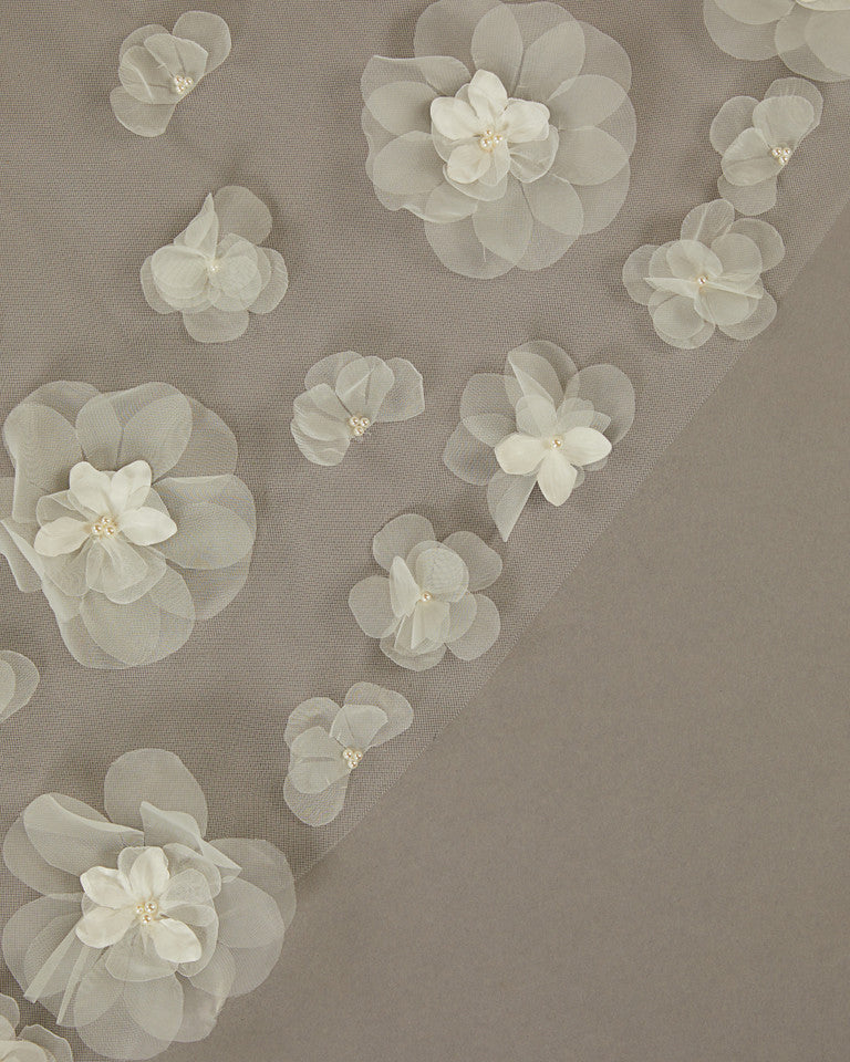 Ivory Cathedral Wedding Veil with 3D Organza Flowers Translucent floral overlay on a brown background