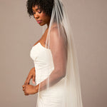 Royal Veil with Raindrop Scatter Woman wearing a wedding dress with a veil against a plain background