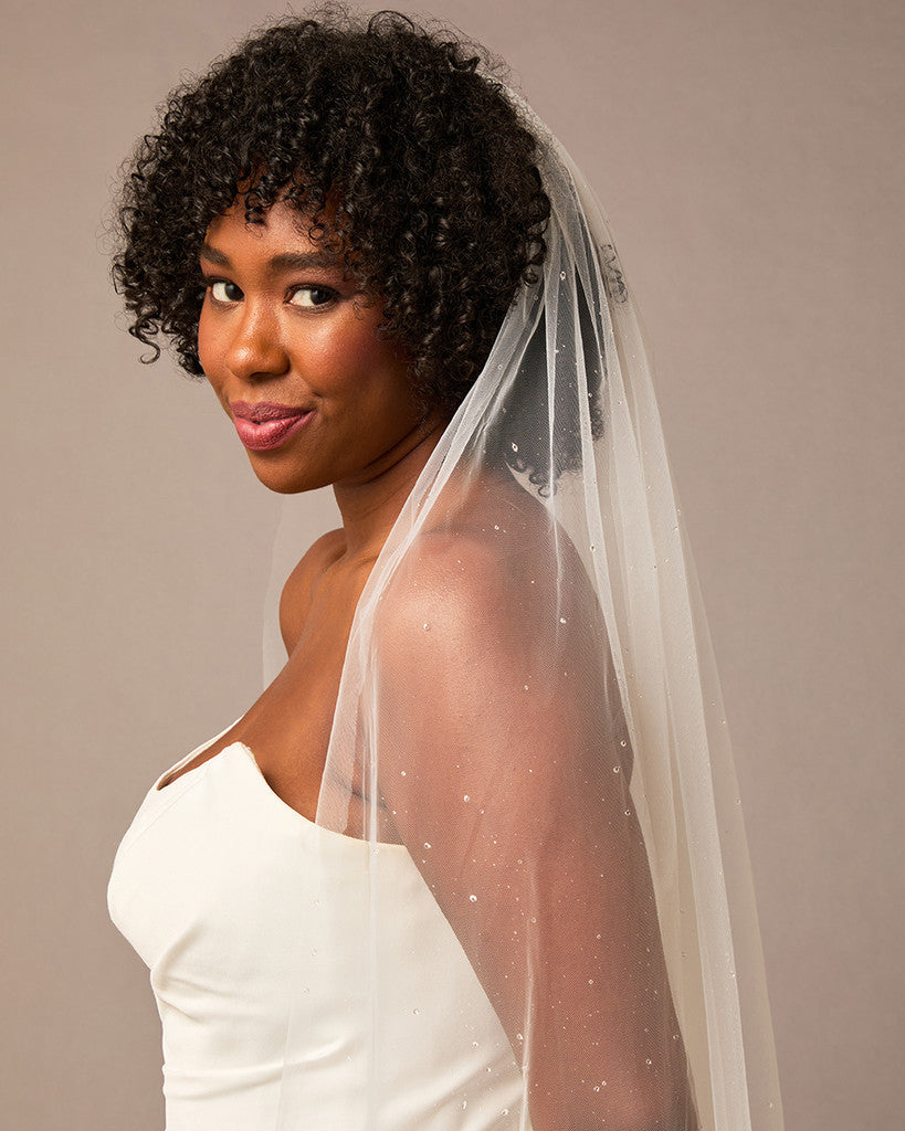 Royal Veil with Raindrop Scatter Woman wearing a wedding dress with a veil against a plain background