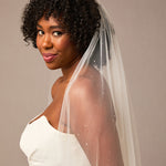 Royal Veil with Raindrop Scatter Woman wearing a wedding dress with a veil against a plain background