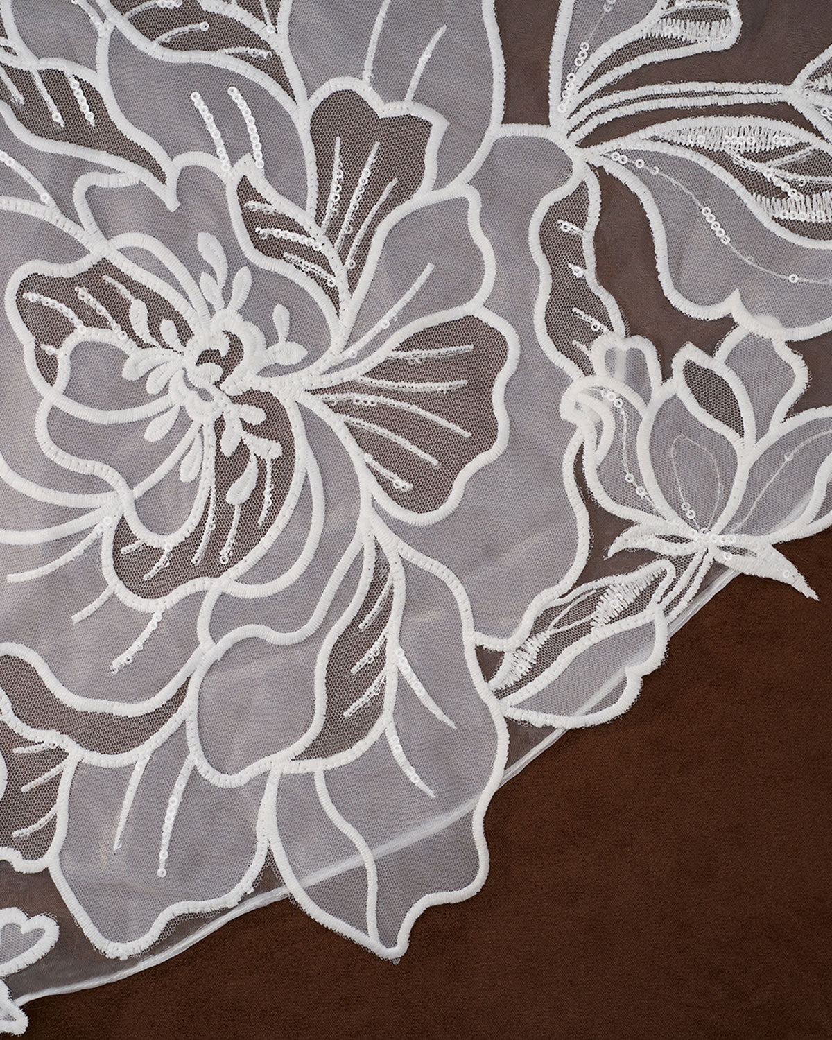 Royal Cathedral Veil with Blusher - Cassandra Lynne Light ivory embroidered floral lace fabric with detailed flower and leaf patterns, laid flat on a dark brown background.