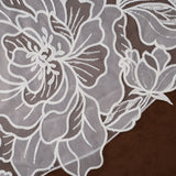 Royal Cathedral Veil with Blusher - Cassandra Lynne Light ivory embroidered floral lace fabric with detailed flower and leaf patterns, laid flat on a dark brown background.