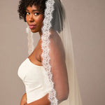  Double Eyelash Lace Cathedral Mantilla VeilWoman wearing a white wedding dress with a lace veil against a plain background