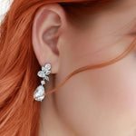Close-up of a woman wearing a silver earring with red hair CZ Bridal earrings from Cassandra Lynne
