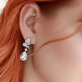 Close-up of a woman wearing a silver earring with red hair CZ Bridal earrings from Cassandra Lynne