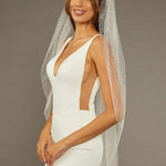 Fingertip Veil with Glitter and Sequins Woman wearing a wedding dress with a veil against a neutral background