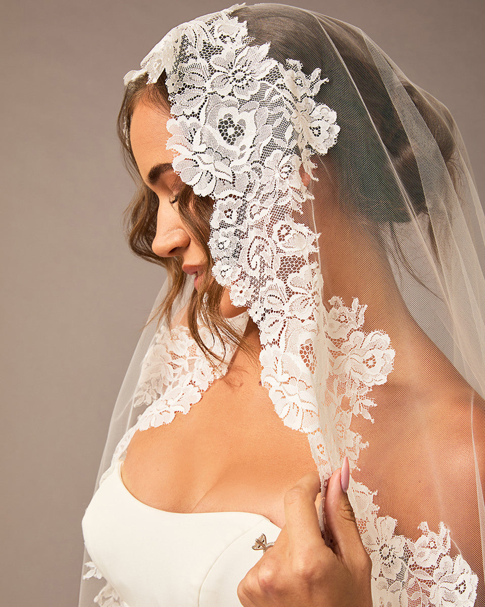 Woman wearing a lace veil with a plain background Mantilla Cathedral Veil with Wide Flower Chantilly Lace