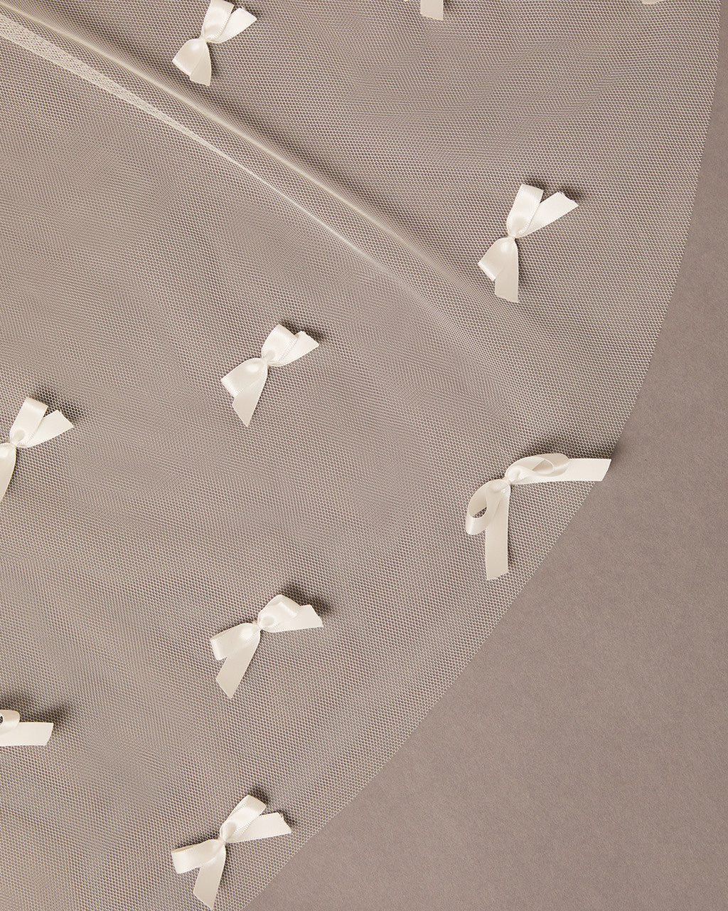 Royal Cathedral Veil of Luxe Tulle and Bows ivory ribbons arranged in a pattern