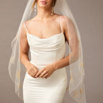 Fingertip Veil with Gold Sequined Dandelion Accents Woman wearing a wedding dress with a sheer veil against a neutral background