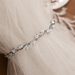 CZ Bracelet Marquise and Round Vine A delicate silver vinebracelet adorned with clear cz, draped over a soft beige tulle fabric.