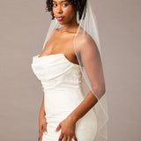 Fingertip Bridal Veil with Iridescent Rhinestones Woman wearing a strapless dress with a veil against a plain background