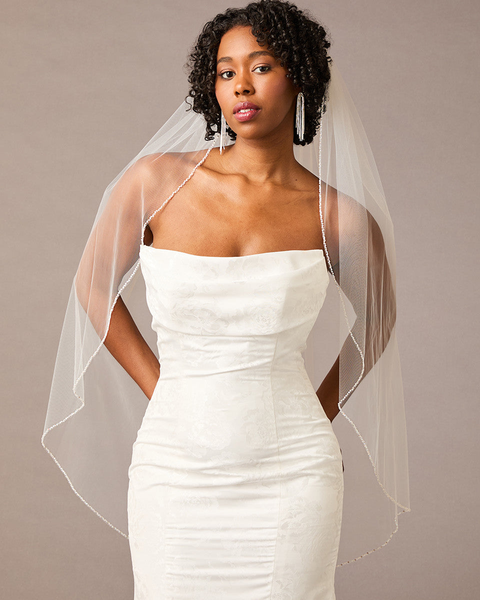 Woman wearing a strapless dress with a sheer veil against a neutral background Fingertip Bridal Veil with Iridescent Rhinestones