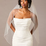 Woman wearing a strapless dress with a sheer veil against a neutral background Fingertip Bridal Veil with Iridescent Rhinestones