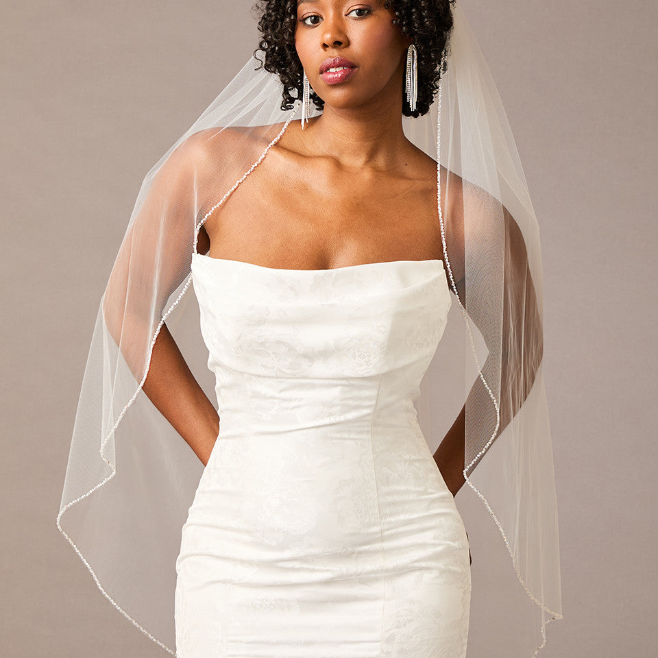Woman wearing a strapless dress with a sheer veil against a neutral background Fingertip Bridal Veil with Iridescent Rhinestones