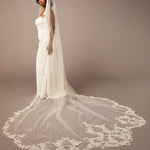 Cathedral Bridal Veil with Venetian Style Lace  wedding dress with a long lace veil on a plain background