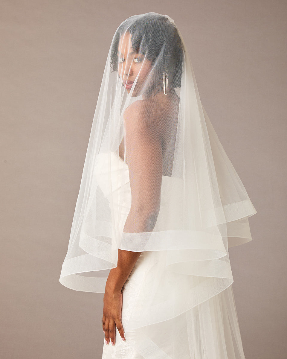 Two Inch Horsehair Trim Waltz Veil Bride wearing a veil against a plain background