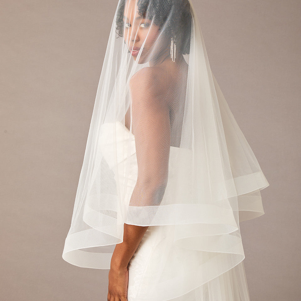 Two Inch Horsehair Trim Waltz Veil Bride wearing a veil against a plain background