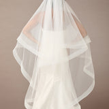 Two Inch Horsehair Trim Waltz Veil  wedding dress with a long veil on a plain background