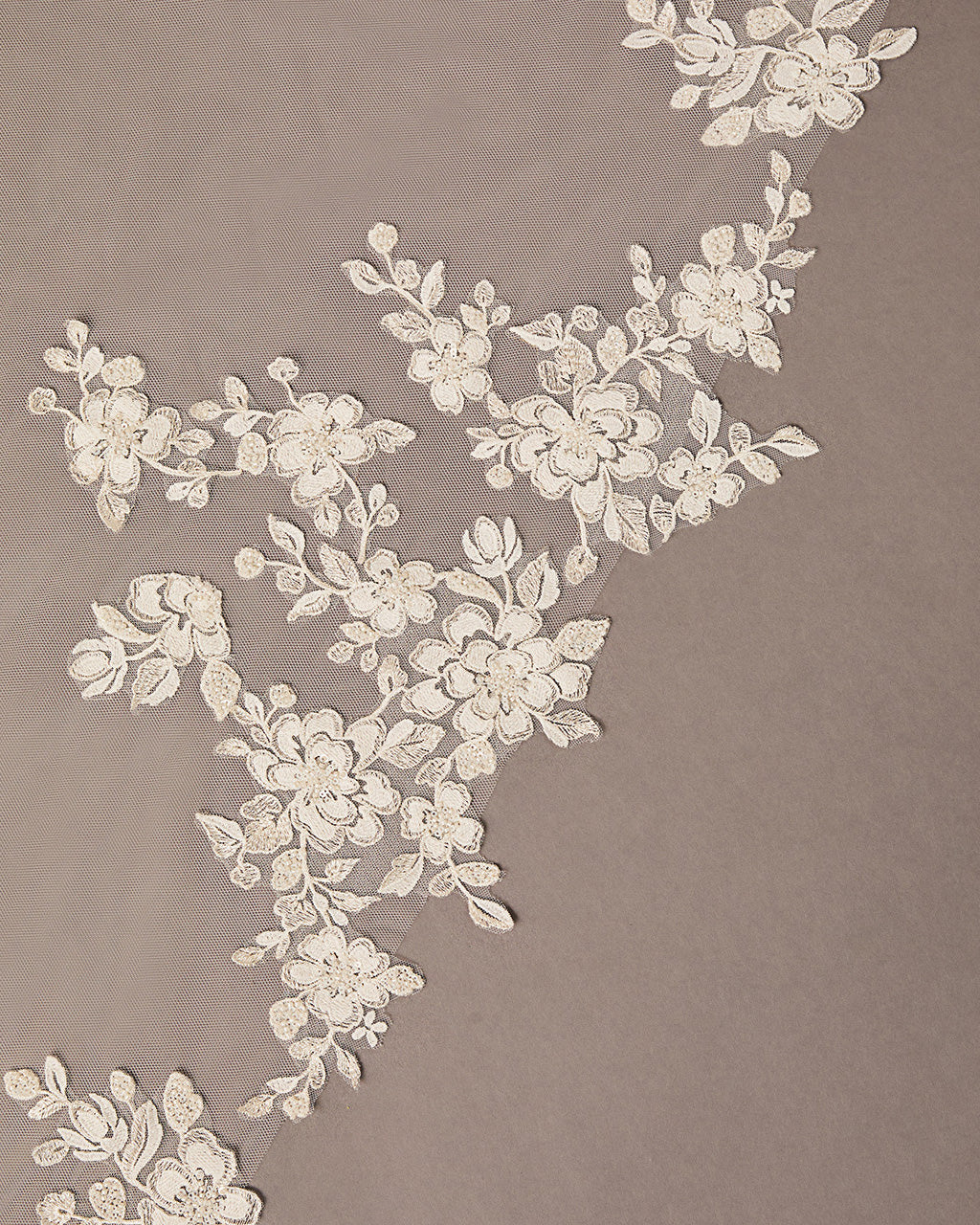 Ivory Luxe Tulle Lace Trim Royal Cathedral Bridal Veil Decorative floral lace pattern on a beige background