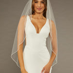 Square Sequins Fingertip Bridal Veil Woman wearing a wedding dress with a sheer veil against a brown background
