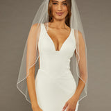 Square Sequins Fingertip Bridal Veil Woman wearing a wedding dress with a sheer veil against a brown background
