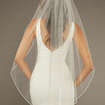 Square Sequins Fingertip Bridal Veil Bride wearing a dress with a sheer veil against a brown background