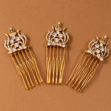 Regal Styled Small Wedding Hair Comb Three gold hair combs with ornate crystal-embellished crowns and long dangling strands, arranged on a warm brown background.