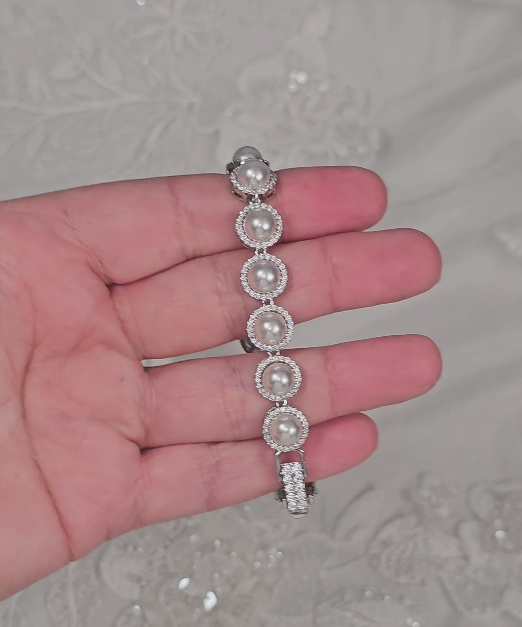 Silver bracelet with pave set ivory pearls and a jeweled clasp