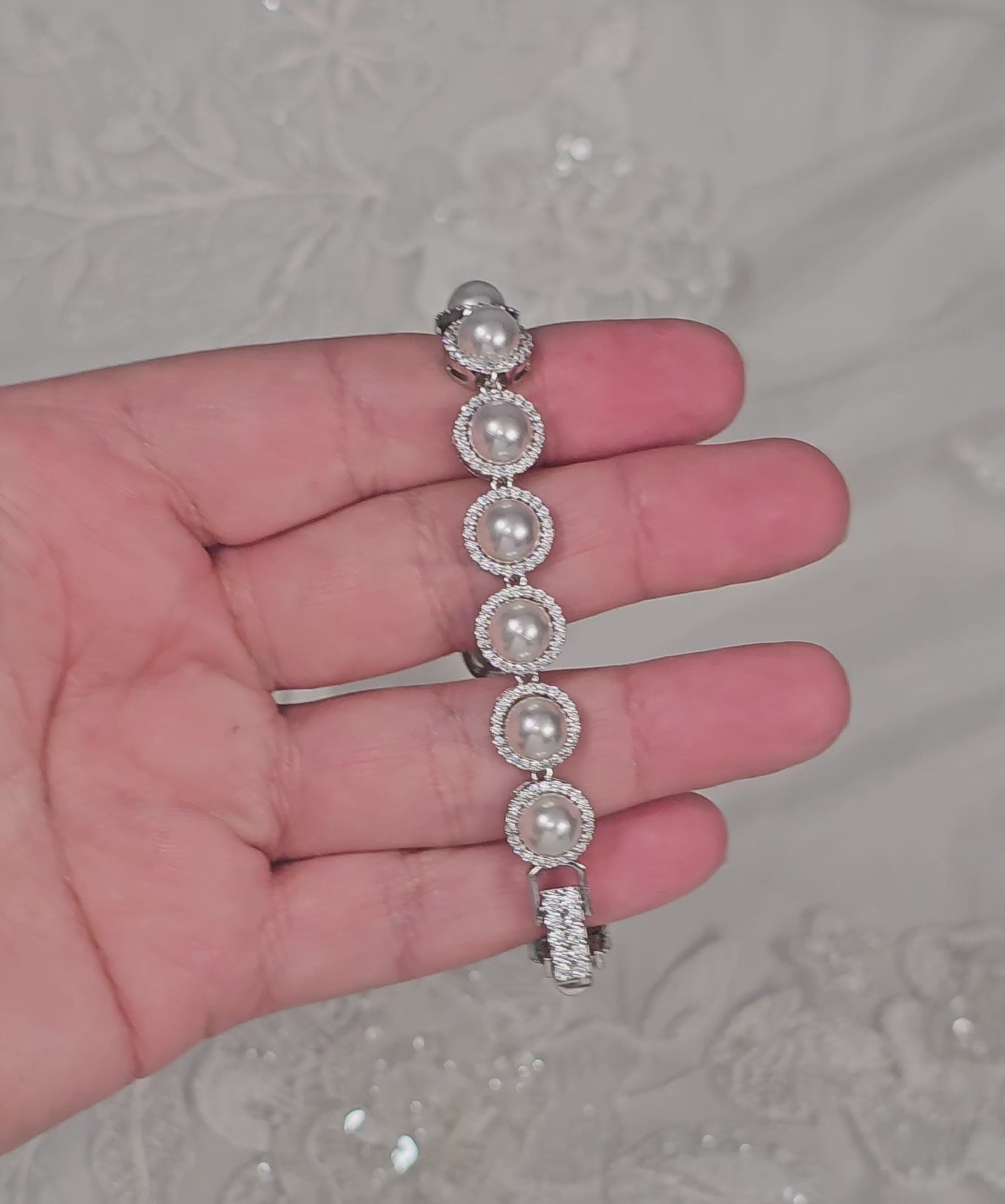 Silver bracelet with pave set ivory pearls and a jeweled clasp