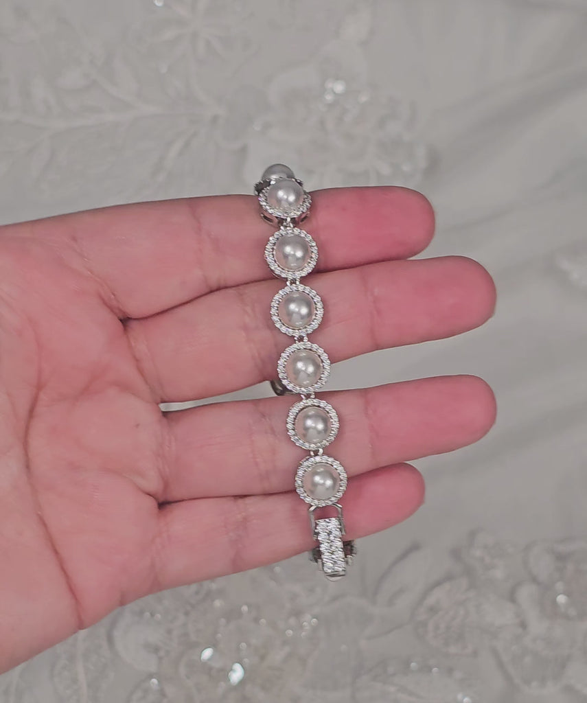Silver bracelet with pave set ivory pearls and a jeweled clasp