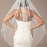 Fingertip Bridal Veil with Rhinestone Chain Trim Person wearing a wedding dress with a veil against a neutral background