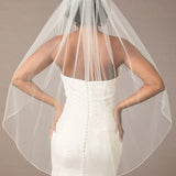 Fingertip Bridal Veil with Rhinestone Chain Trim Person wearing a wedding dress with a veil against a neutral background