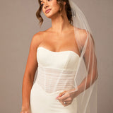 Woman wearing a white strapless wedding dress with a sheer veil against a neutral background Partial Lace and Organza Flowers Cathedral Wedding Veil