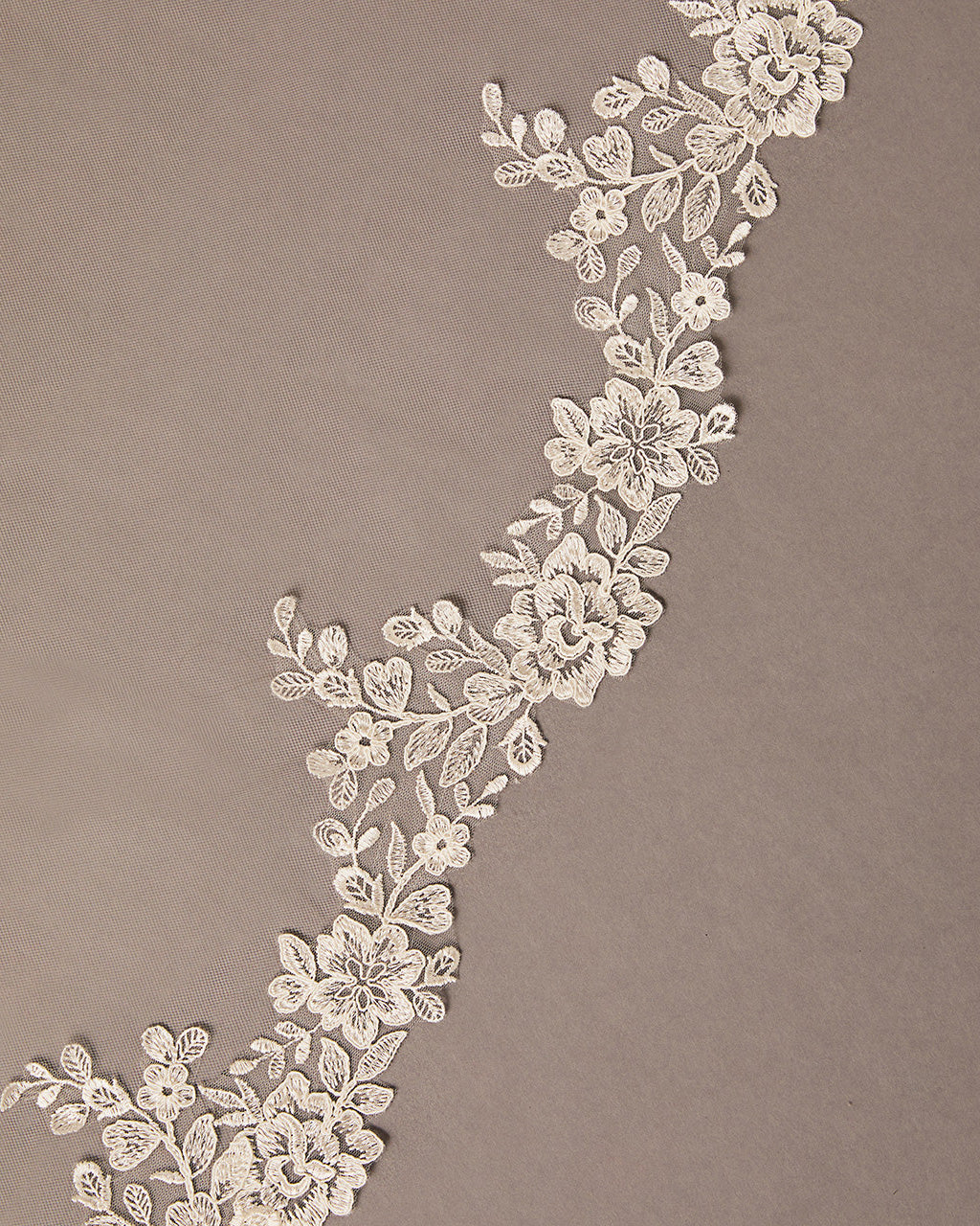 Partial Lace Trim Cathedral Bridal Veil Decorative floral lace on a brown background
