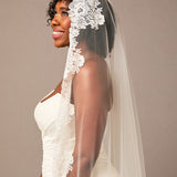 Bride wearing a white lace veil against a plain background Mantilla Cathedral Veil with Wide Flower Chantilly Lace