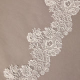 Close-up of floral lace trim on a beige background Mantilla Cathedral Veil with Wide Flower Chantilly Lace