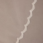 Bridal Veil with Scalloped Small Eyelash Lace Decorative lace trim on a beige background